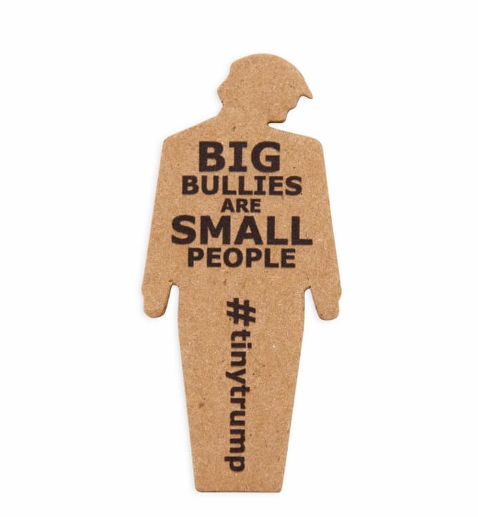 Close up of a tiny trump with the slogan "Big Bullies Are Small People"